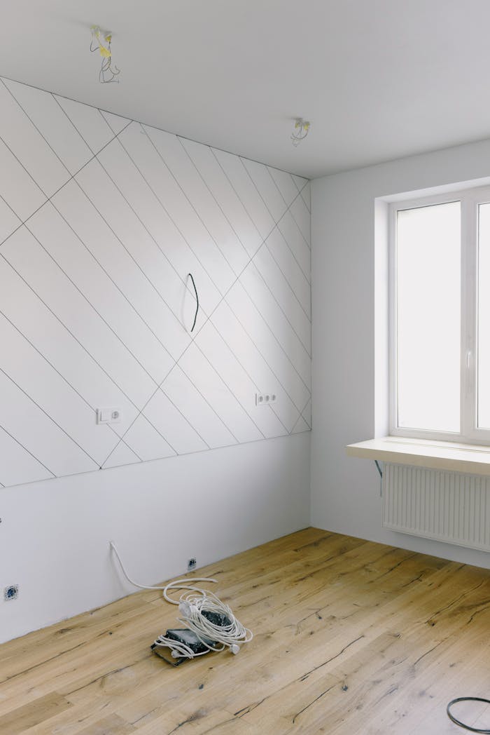 gallery-2 Bright modern room during renovation with wooden floors and white walls.