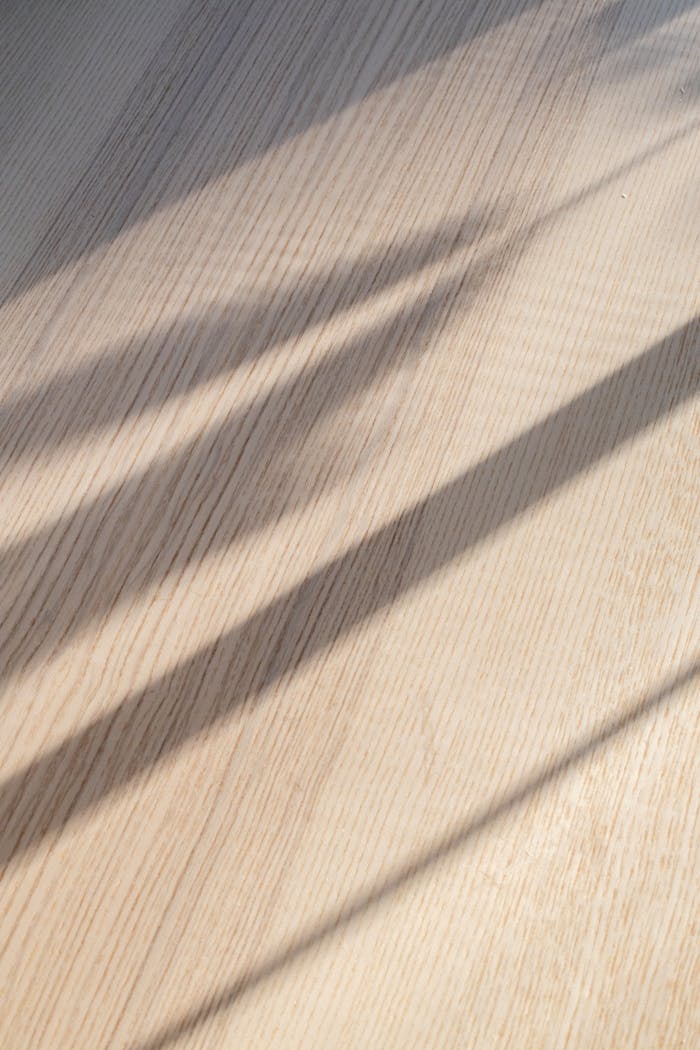 why-choose-us From above of curtain shadow on wooden floor in room on sunny day