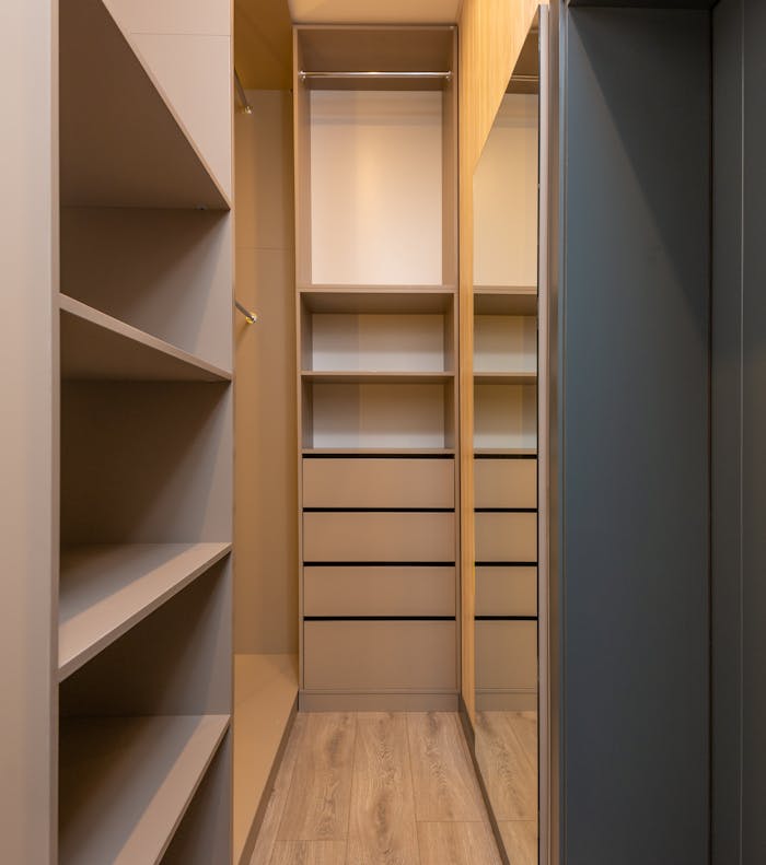 Sleek modern wardrobe with wooden shelves and drawers, showcasing minimalist design for organized storage.